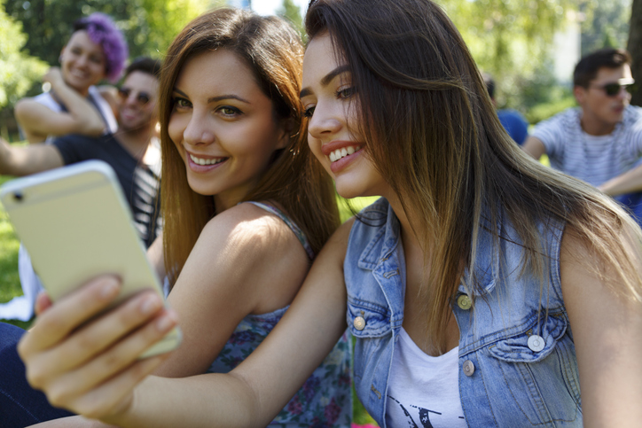 Beautiful girls taking selfie photos outdoor